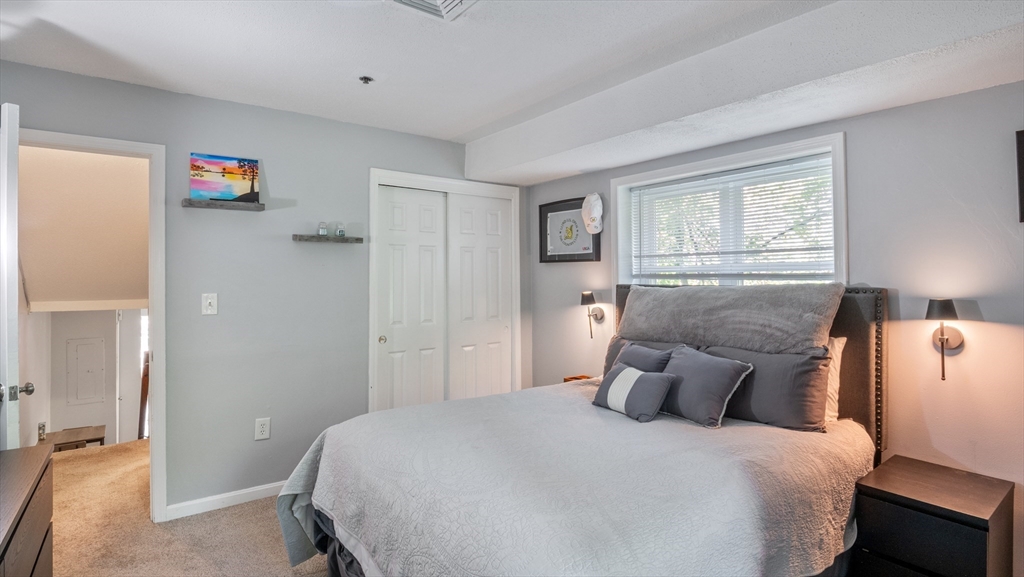 4 Duck Pond Road, Unit 218 Beverly, MA 01915 - Photo 11 of 19 a bedroom with a bed and a window
