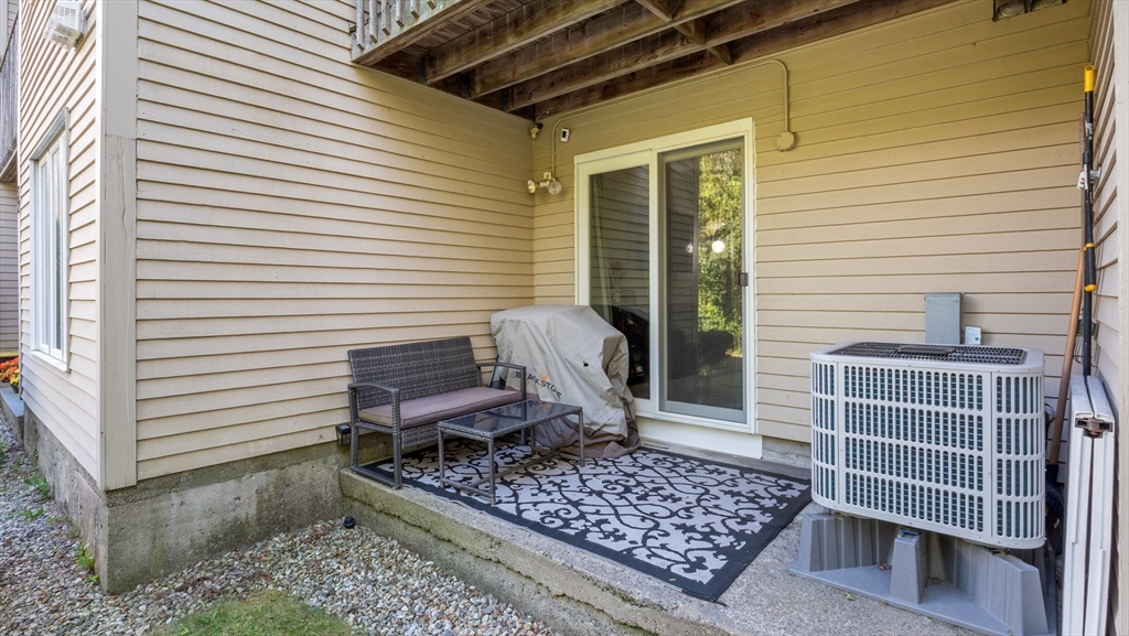 4 Duck Pond Road, Unit 218 Beverly, MA 01915 - Photo 12 of 19 a view of a chair and table on the deck