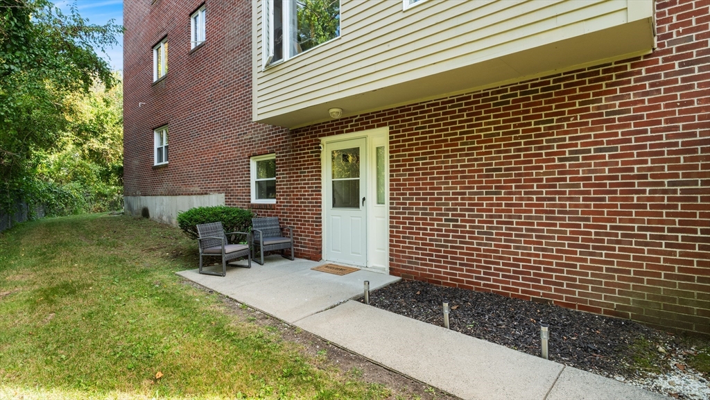 4 Duck Pond Road, Unit 218 Beverly, MA 01915 - Photo 14 of 19 a view of backyard with a chair and table