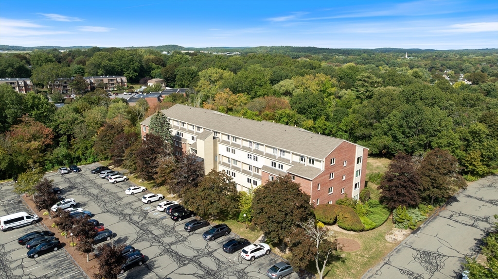4 Duck Pond Road, Unit 218 Beverly, MA 01915 - Photo 16 of 19 a view of a city with lush green forest
