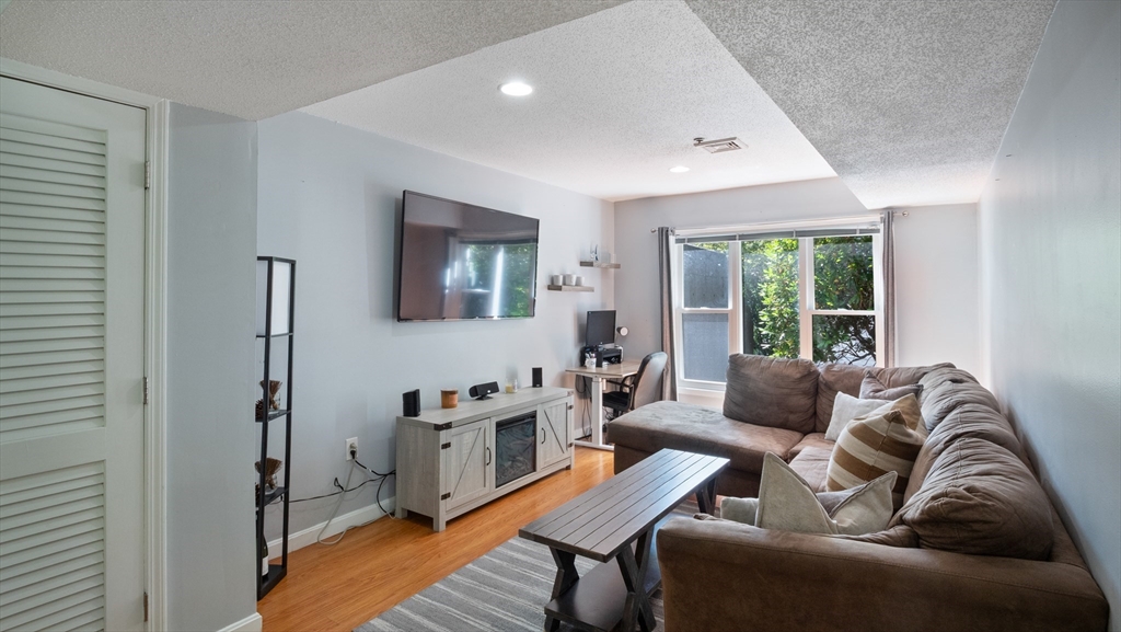 4 Duck Pond Road, Unit 218 Beverly, MA 01915 - Photo 2 of 19 a living room with furniture and a window