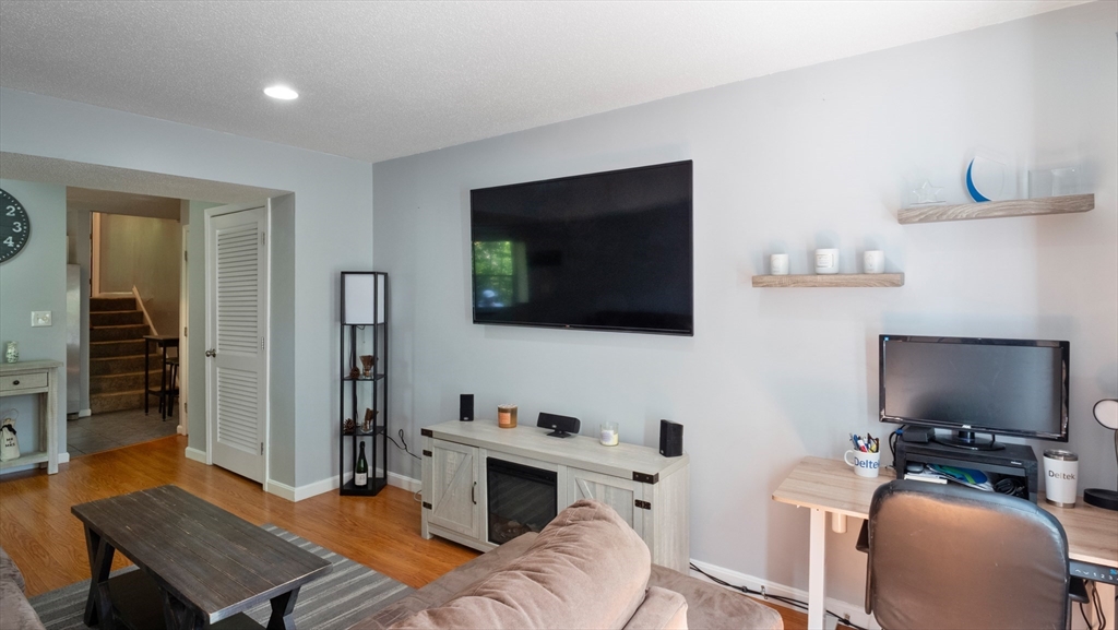 4 Duck Pond Road, Unit 218 Beverly, MA 01915 - Photo 3 of 19 a view of a livingroom with furniture and a flat screen tv