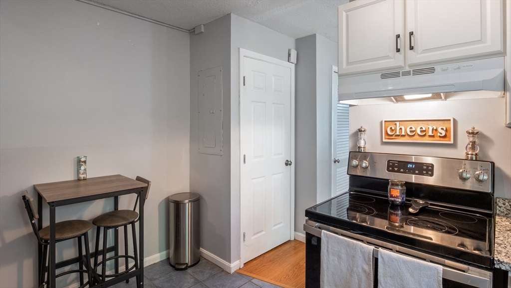 4 Duck Pond Road, Unit 218 Beverly, MA 01915 - Photo 5 of 19 a kitchen with stainless steel appliances a refrigerator and microwave