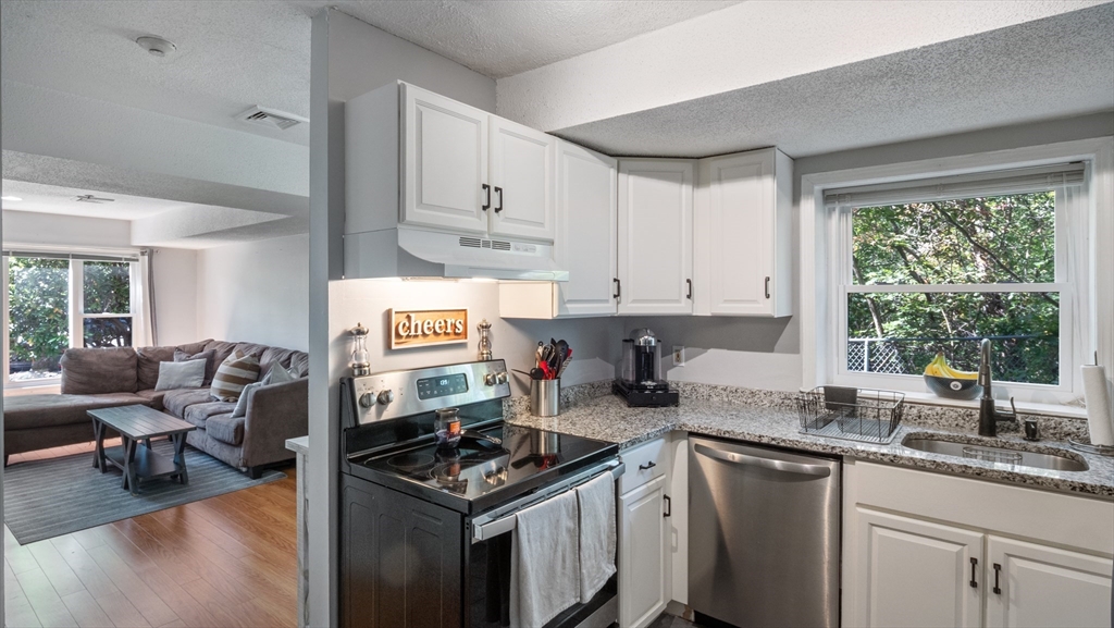 4 Duck Pond Road, Unit 218 Beverly, MA 01915 - Photo 6 of 19 a kitchen with stainless steel appliances granite countertop a stove and a sink