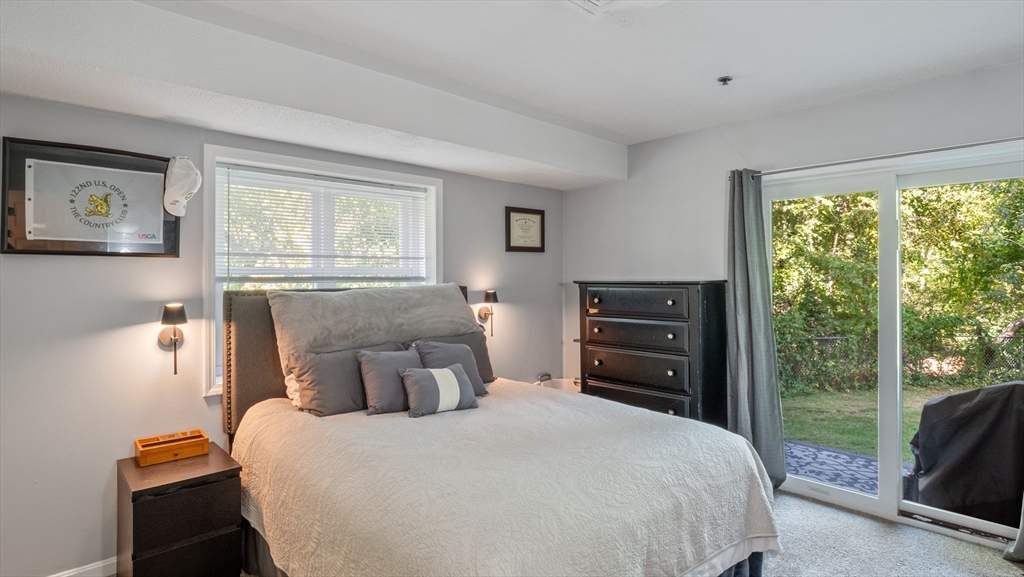 4 Duck Pond Road, Unit 218 Beverly, MA 01915 - Photo 10 of 19 a bedroom with a bed and a large window