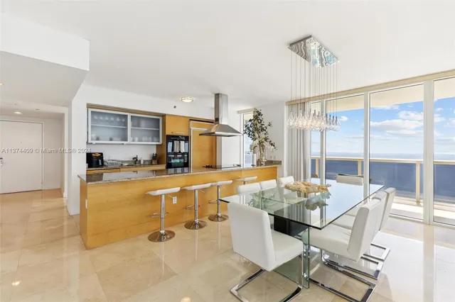 a view of a dining room with furniture wooden floor and a kitchen