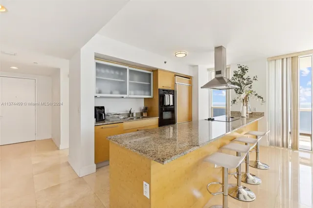 a bedroom with a large bed and a large window