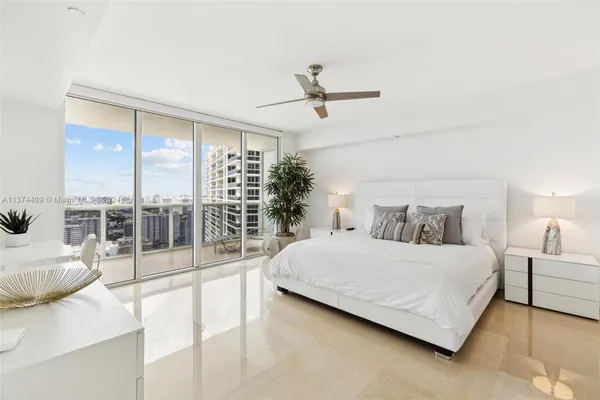 a bedroom with a large bed and a large window