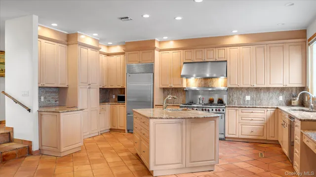 a kitchen with cabinets and a refrigerator
