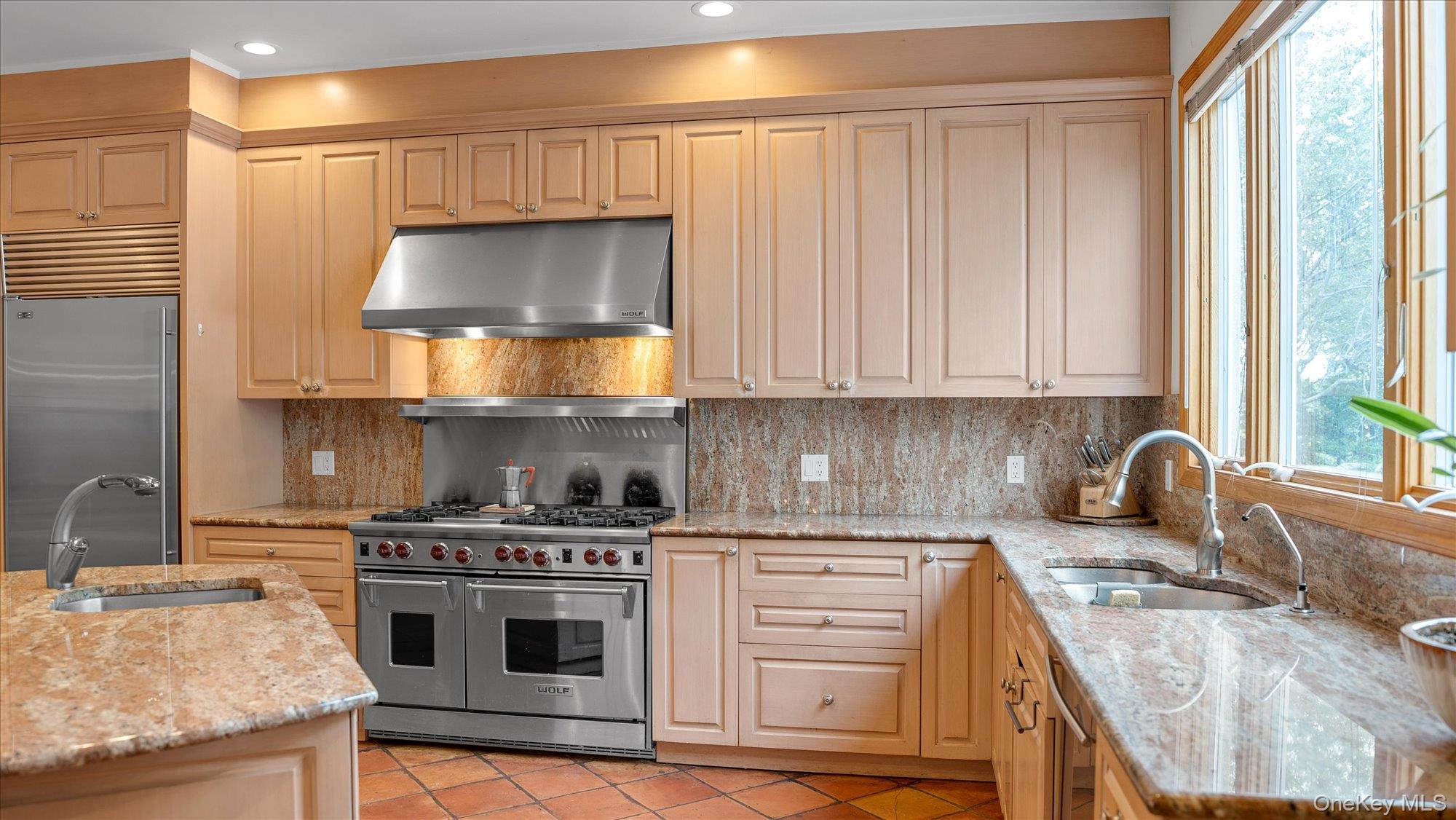 3400 Dignans Road Cutchogue, NY 11935 - Photo 15 of 34 Kitchen with light stone counters, under cabinet range hood, high end appliances, plenty of natural light, and recessed lighting