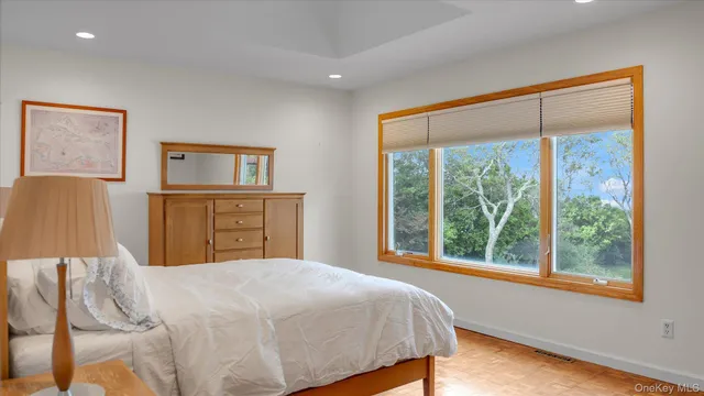 a bedroom with a large bed and a window