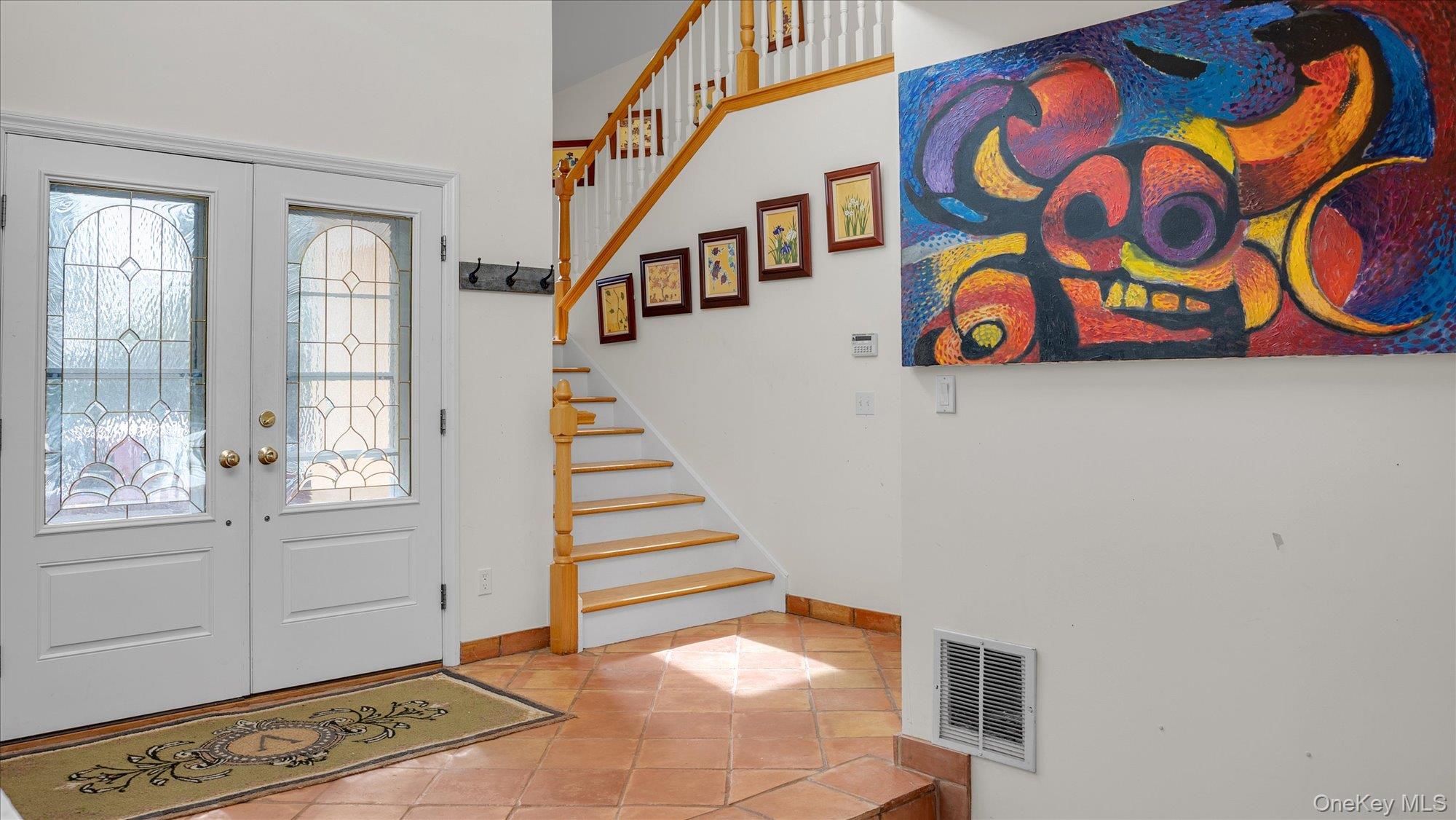 3400 Dignans Road Cutchogue, NY 11935 - Photo 5 of 34 Foyer entrance with tile patterned flooring, french doors, and stairs