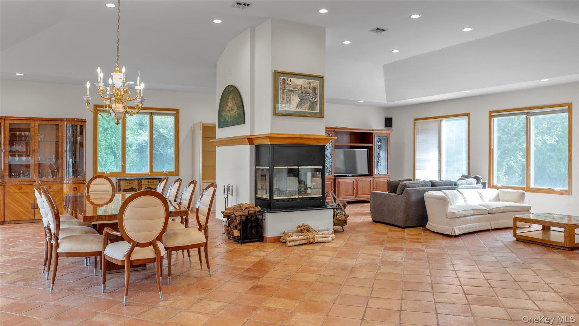 3400 Dignans Road Cutchogue, NY 11935 - Photo 9 of 34 Living area with recessed lighting, a chandelier, high vaulted ceiling, and light tile patterned floors