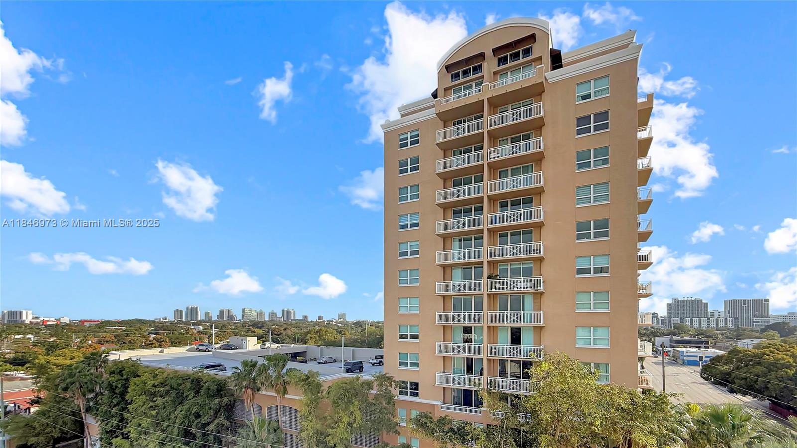 2665 Southwest 37th Avenue, Unit 408 Miami, FL 33133 - Photo 1 of 30 a view of a building with a yard