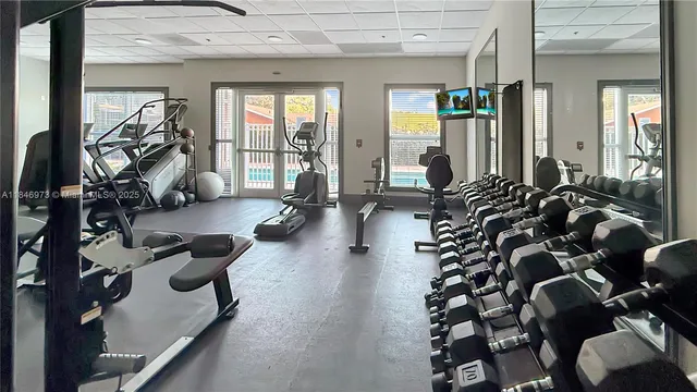 a room with gym equipment and a large window
