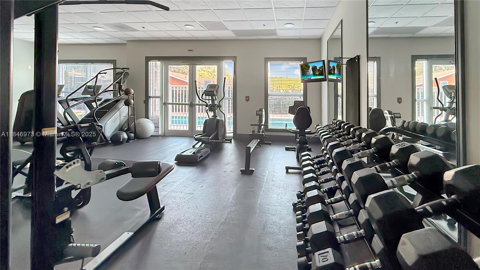 2665 Southwest 37th Avenue, Unit 408 Miami, FL 33133 - Photo 19 of 30 a room with gym equipment and a large window