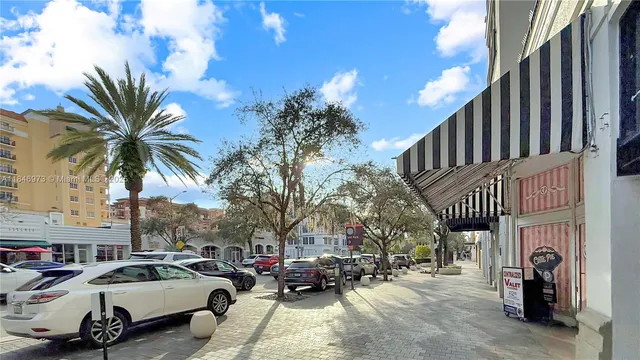 a couple of cars parked in front of buildings
