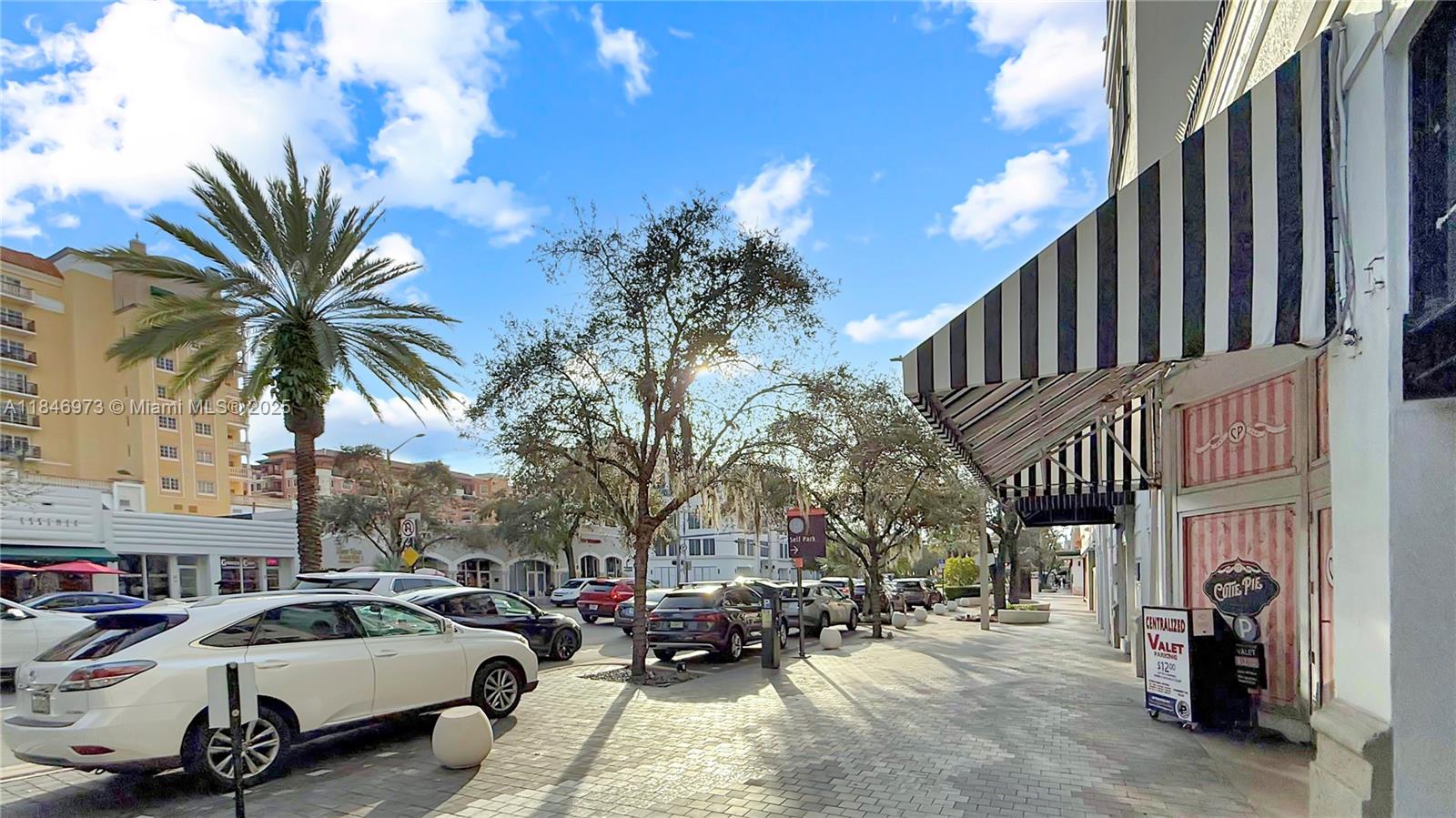 2665 Southwest 37th Avenue, Unit 408 Miami, FL 33133 - Photo 27 of 30 a couple of cars parked in front of buildings