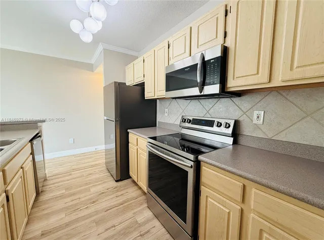 a kitchen with stainless steel appliances granite countertop a refrigerator stove and microwave