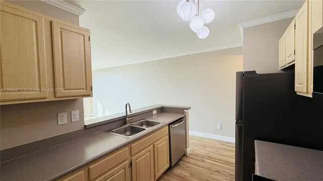 a kitchen with a sink and a refrigerator