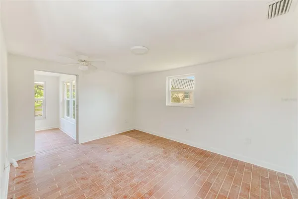 an empty room with windows and closet