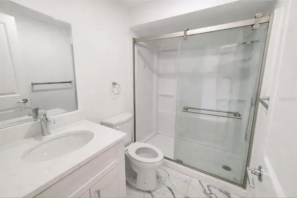 a bathroom with a sink toilet and shower