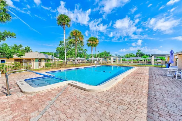 a view of swimming pool with outdoor seating and a patio