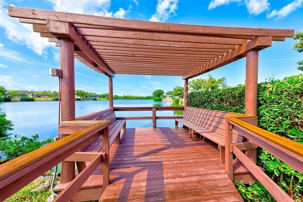 a balcony with wooden floor and outdoor space