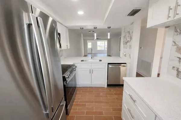 a kitchen with a sink a refrigerator a washer and dryer