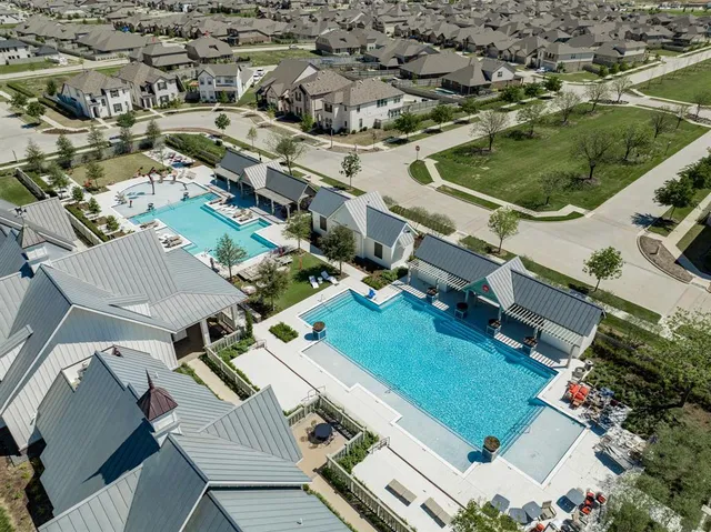 an aerial view of residential houses with outdoor space