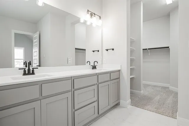 a spacious bathroom with double sink and a mirror
