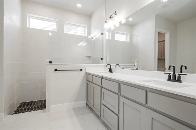 a bathroom with a sink a double vanity and a mirror