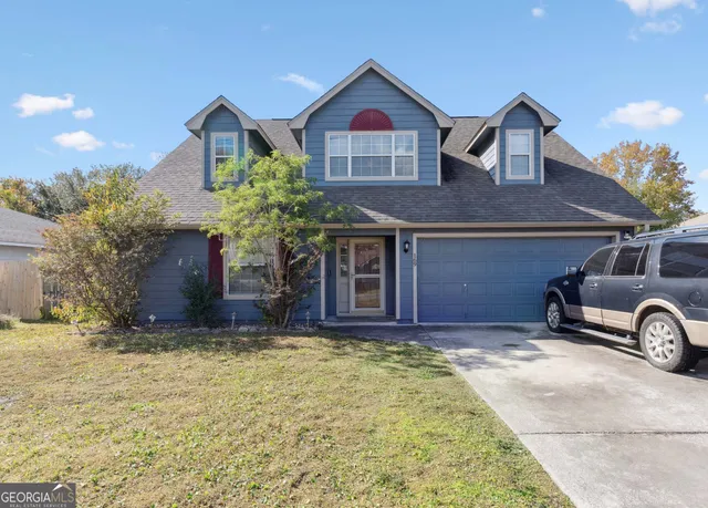 a front view of a house with a yard and garage