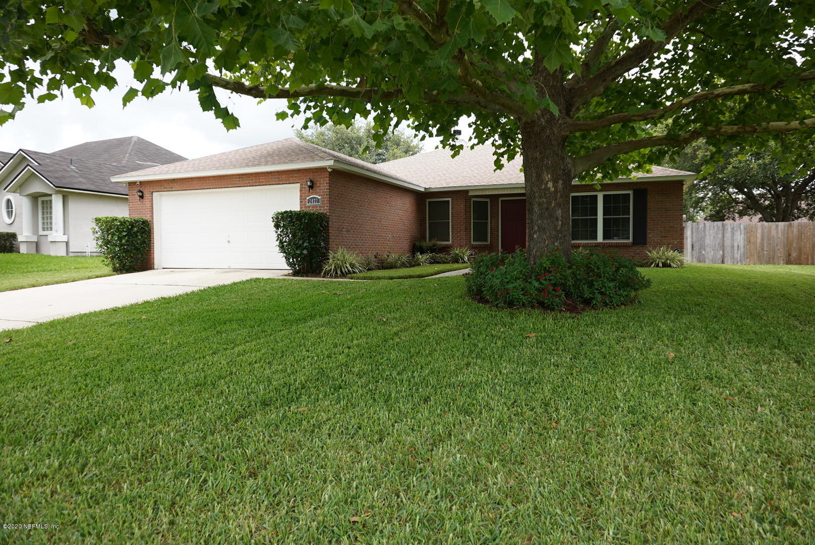 2427 Paris Mill Road Jacksonville, FL 32221 - Photo 1 of 14 a front view of a house with a garden and yard