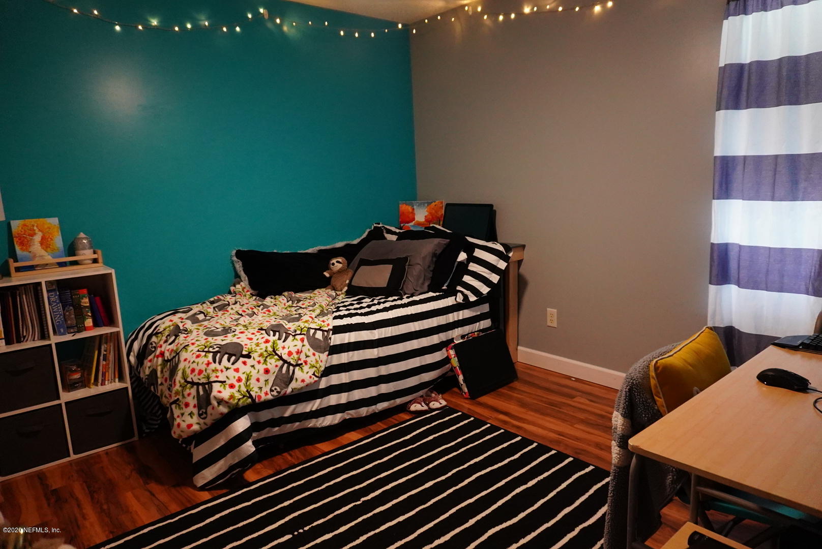 2427 Paris Mill Road Jacksonville, FL 32221 - Photo 11 of 14 a bedroom with a bed and a bookshelf