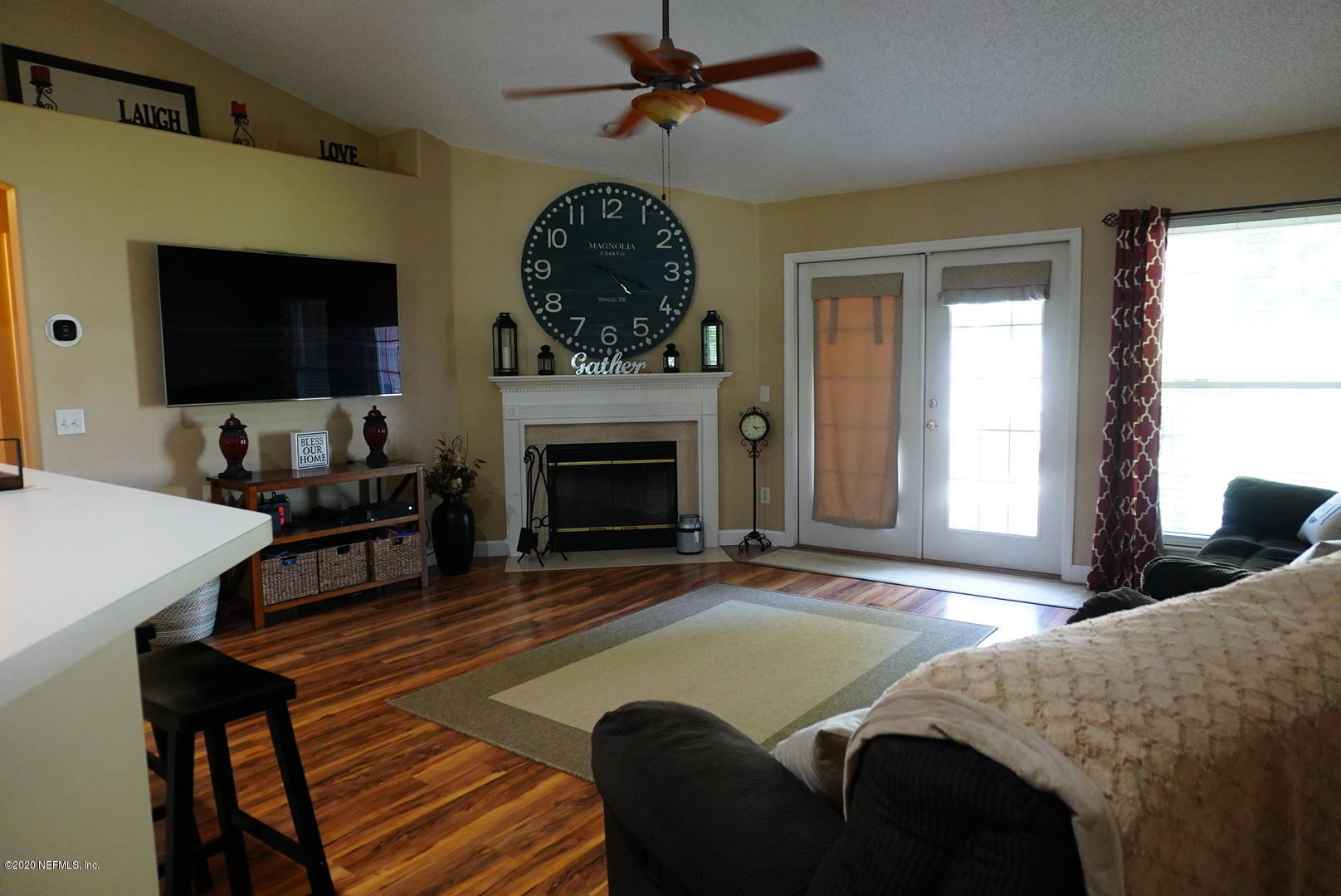 2427 Paris Mill Road Jacksonville, FL 32221 - Photo 3 of 14 a living room with furniture a flat screen tv and a fireplace