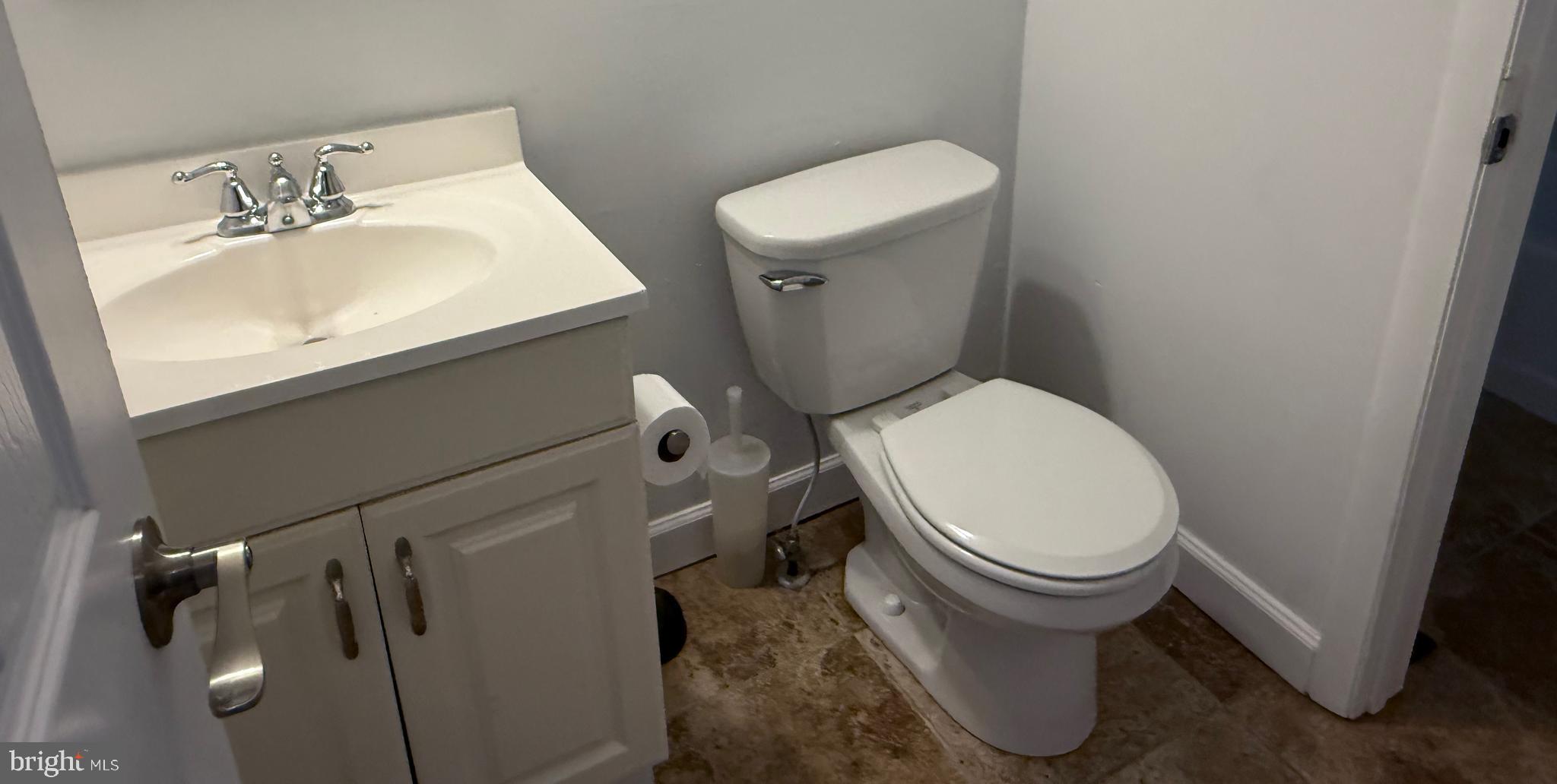 1055 Bulman Harbour Pasadena, MD 21122 - Photo 18 of 36 a white toilet sitting next to a bathroom sink