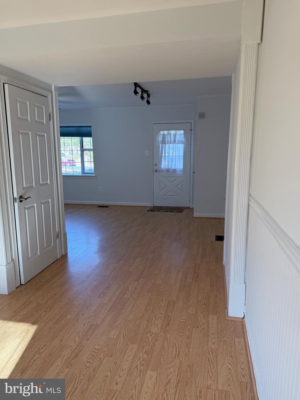 1055 Bulman Harbour Pasadena, MD 21122 - Photo 7 of 36 an empty room with wooden floor and windows