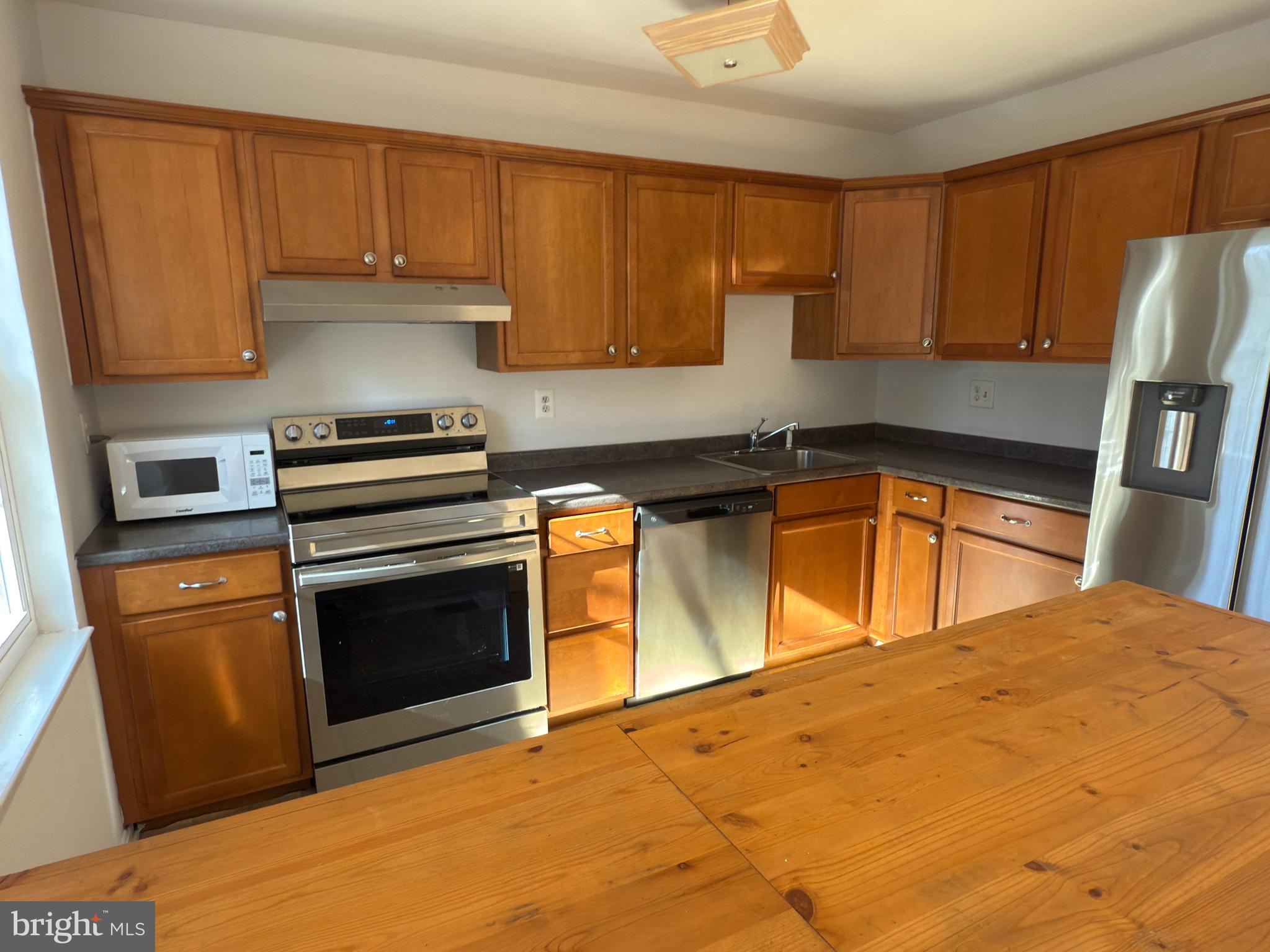 1055 Bulman Harbour Pasadena, MD 21122 - Photo 8 of 36 a kitchen with a sink a stove and cabinets