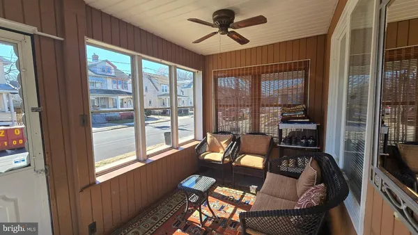 a living room with furniture large windows and a flat screen tv