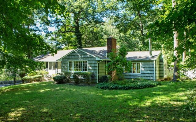 69 Ridgewood Road Ridgefield, CT 06877 - Photo 1 of 1 a front view of a house with garden