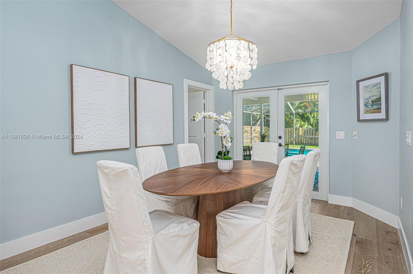 138 Buttonwood Way Tequesta, FL 33469 - Photo 13 of 27 a view of a dining room with furniture a chandelier and wooden floor