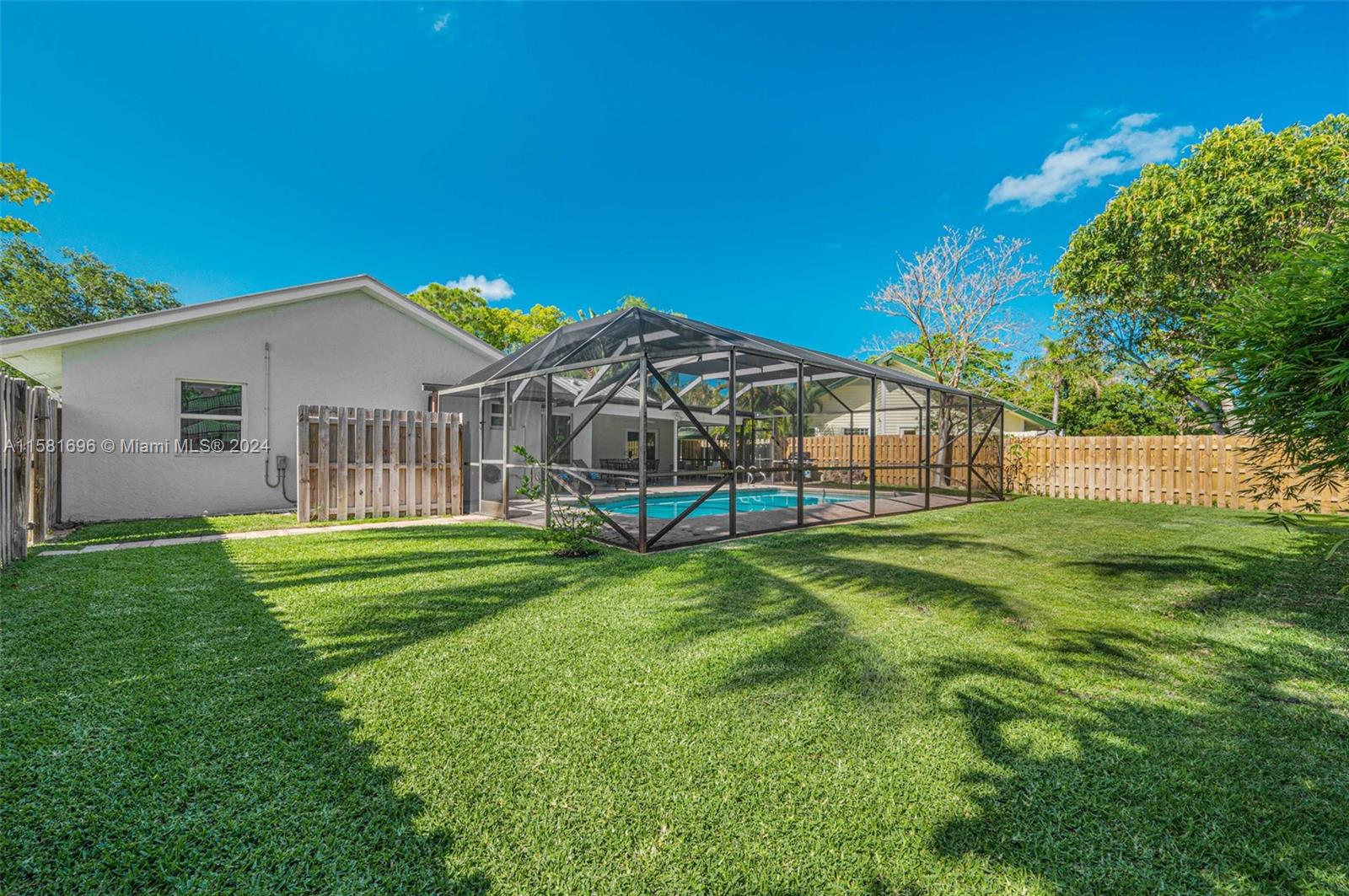 138 Buttonwood Way Tequesta, FL 33469 - Photo 15 of 27 a view of a house with a backyard and a garden