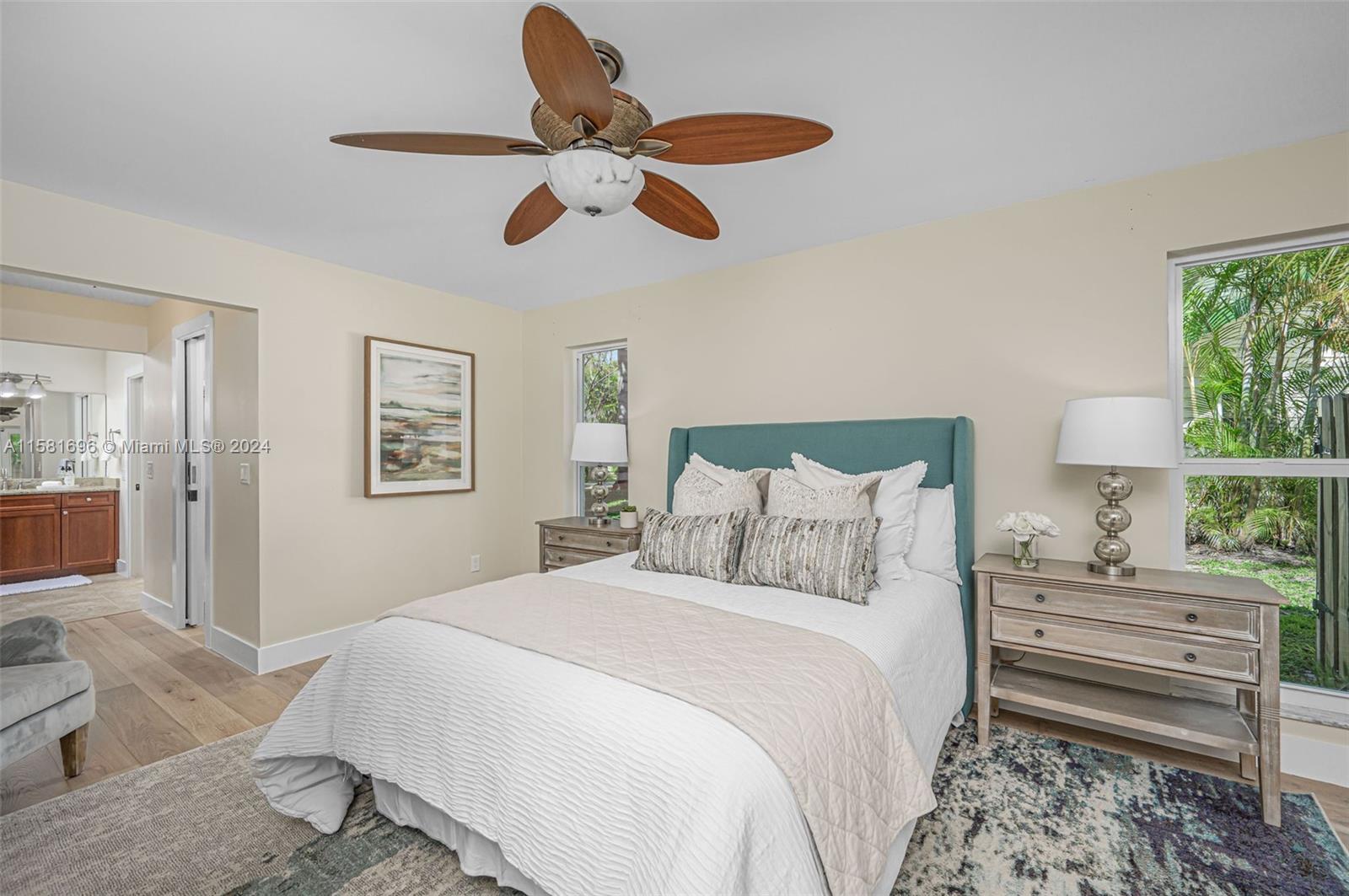 138 Buttonwood Way Tequesta, FL 33469 - Photo 17 of 27 a bedroom with a bed and a chandelier