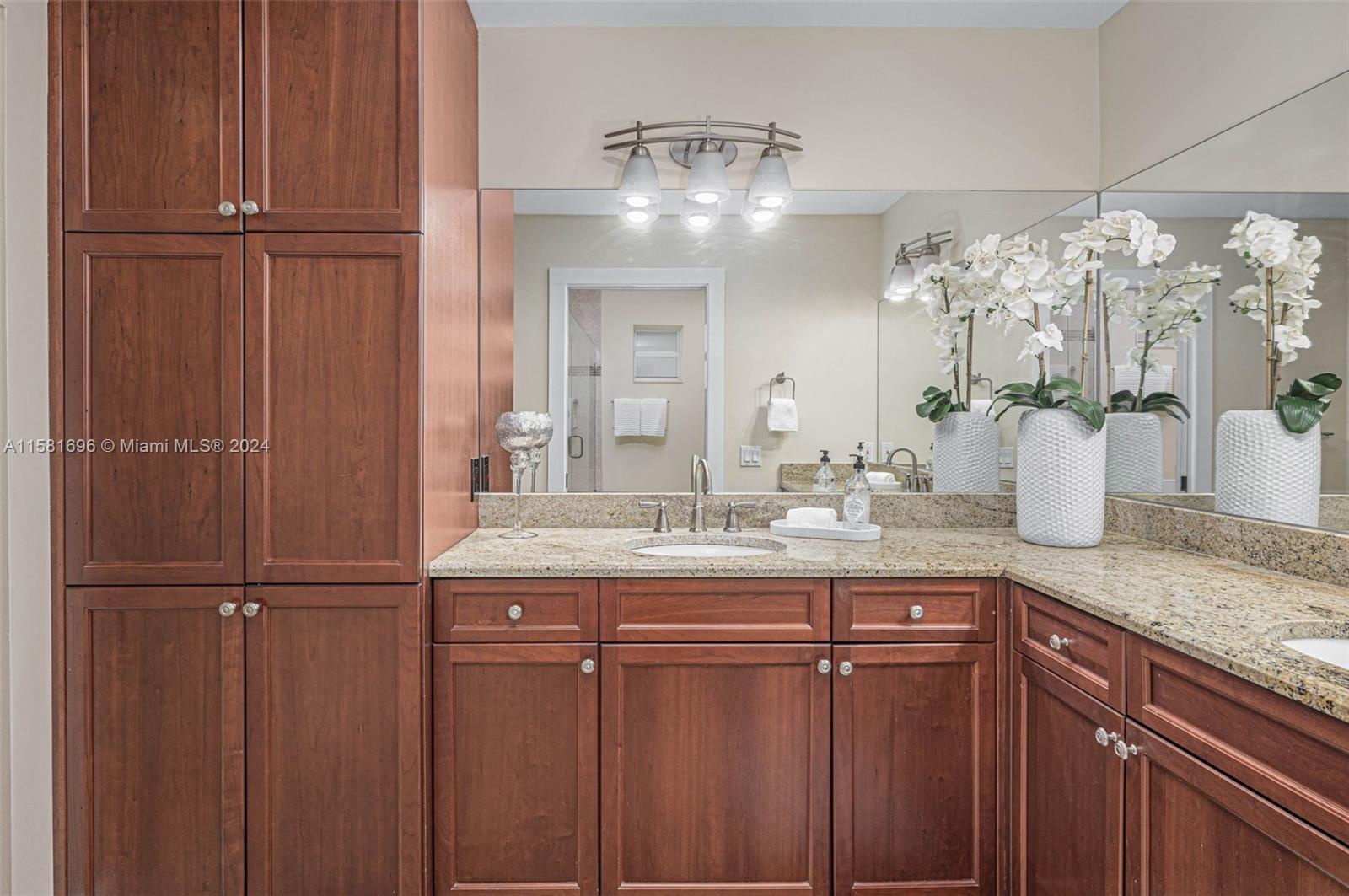 138 Buttonwood Way Tequesta, FL 33469 - Photo 19 of 27 a bathroom with a granite countertop sink and a mirror