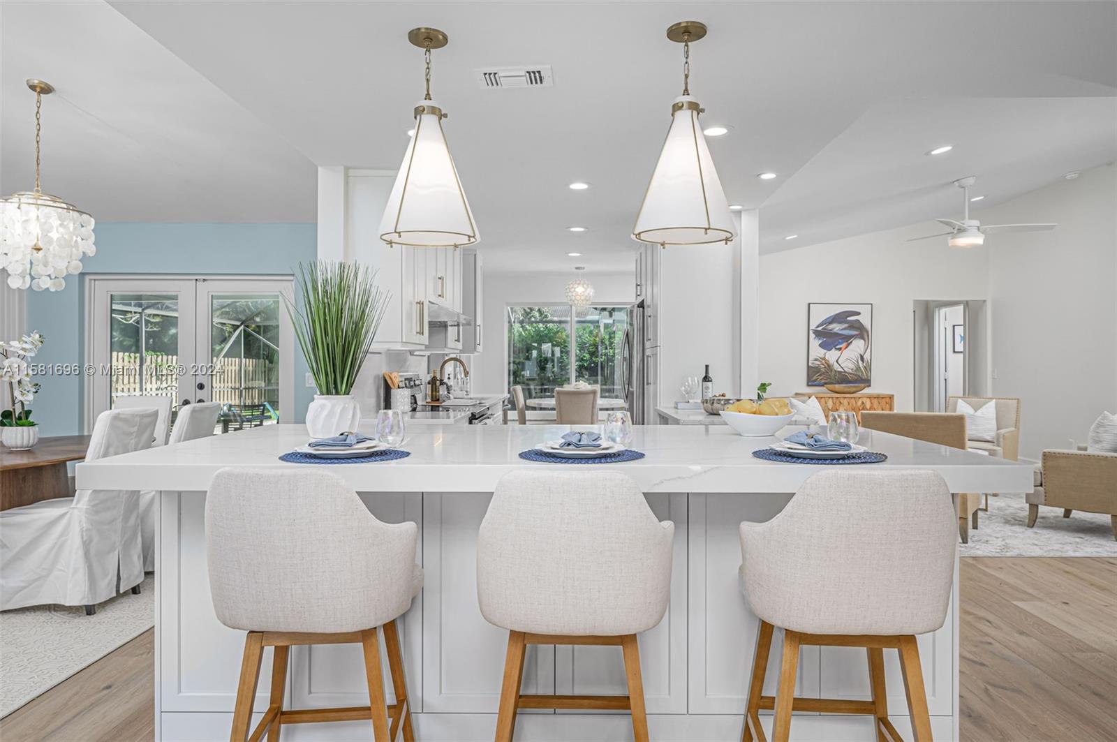 138 Buttonwood Way Tequesta, FL 33469 - Photo 2 of 27 a dining room with stainless steel appliances kitchen island a table chairs and a sink