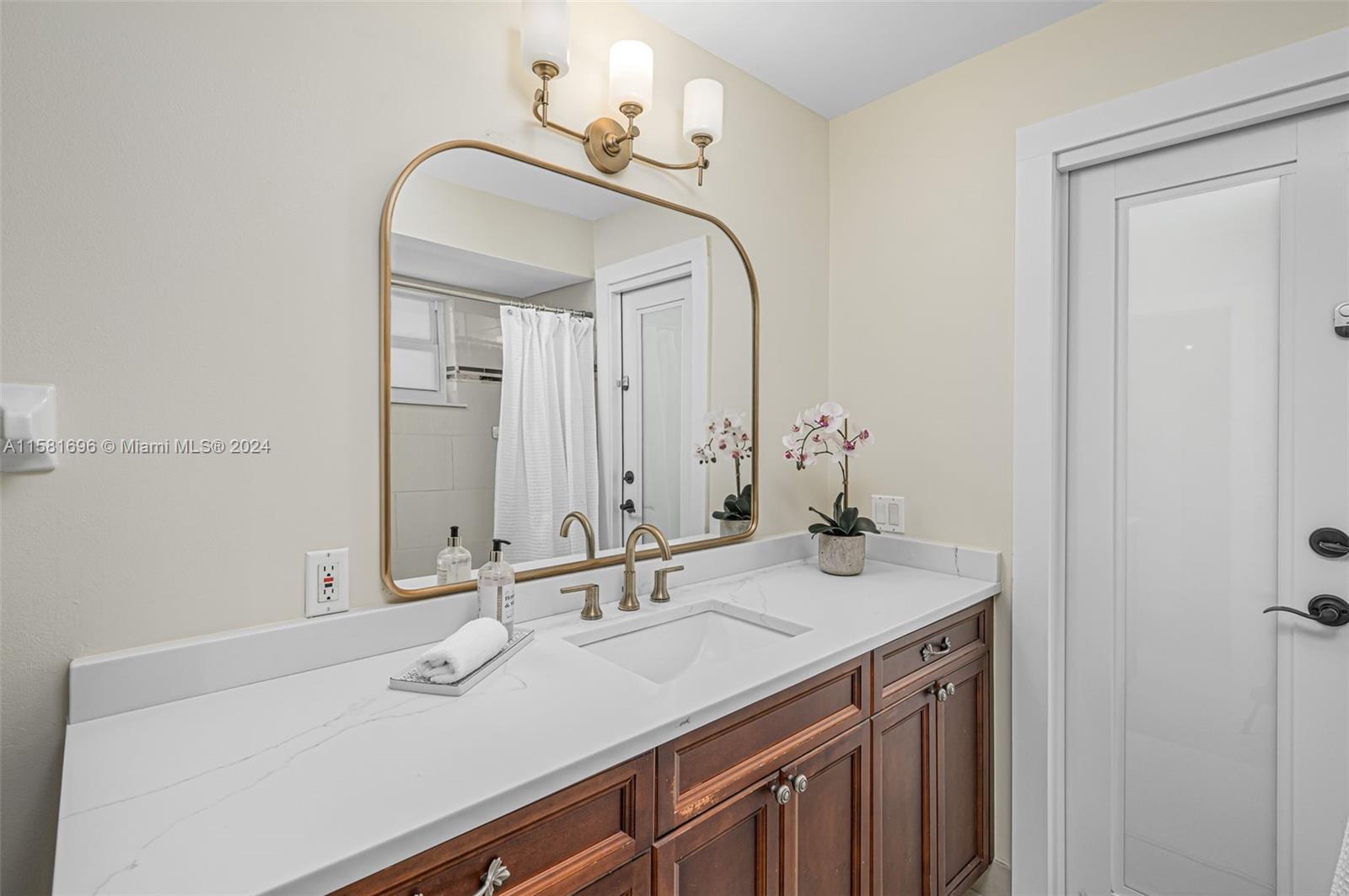 138 Buttonwood Way Tequesta, FL 33469 - Photo 24 of 27 a bathroom with a sink and a mirror