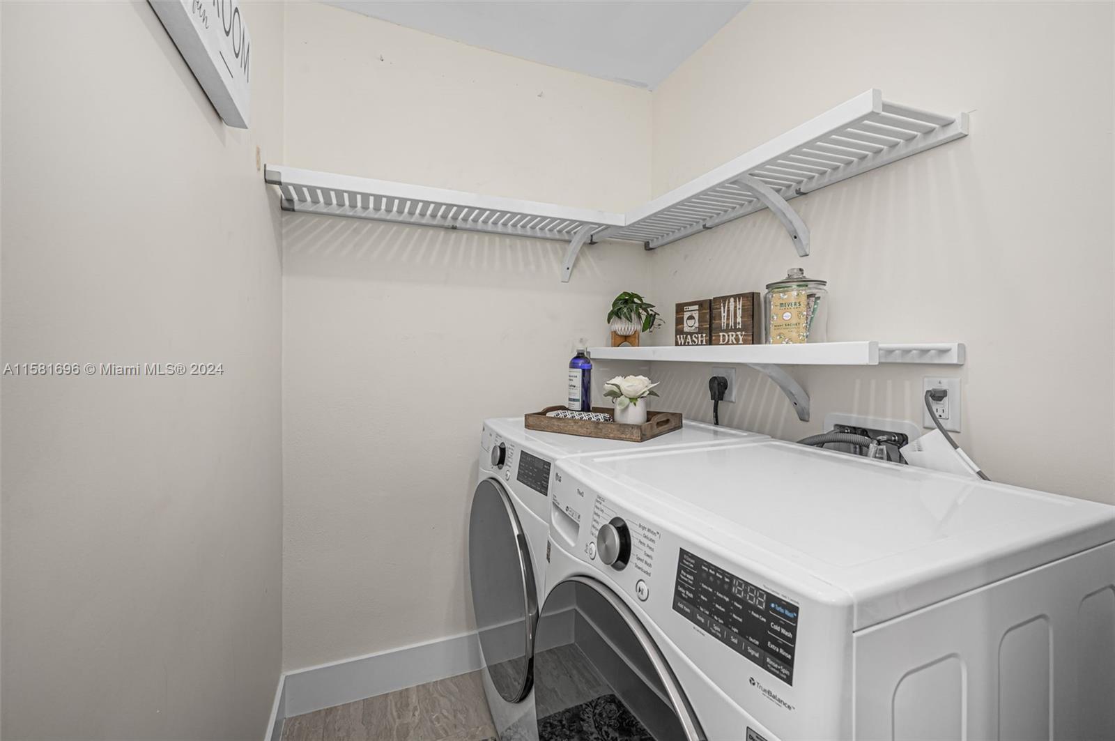 138 Buttonwood Way Tequesta, FL 33469 - Photo 25 of 27 a utility room with dryer and washer