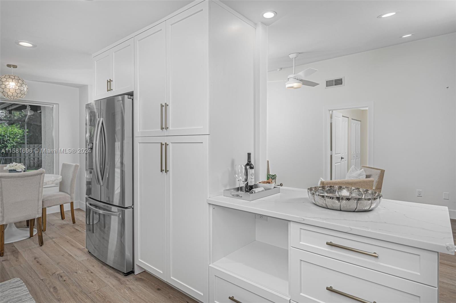 138 Buttonwood Way Tequesta, FL 33469 - Photo 10 of 27 a kitchen with stainless steel appliances kitchen island granite countertop a refrigerator and a stove