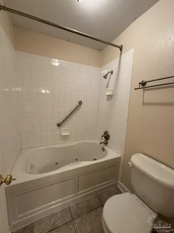 a bathroom with a toilet and a bathtub